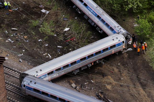 Emergency workers and Amtrak personnel inspect a derailed Amtrak train in Philadelphia, Pennsylvania May 13, 2015. REUTERS/Lucas Jackson